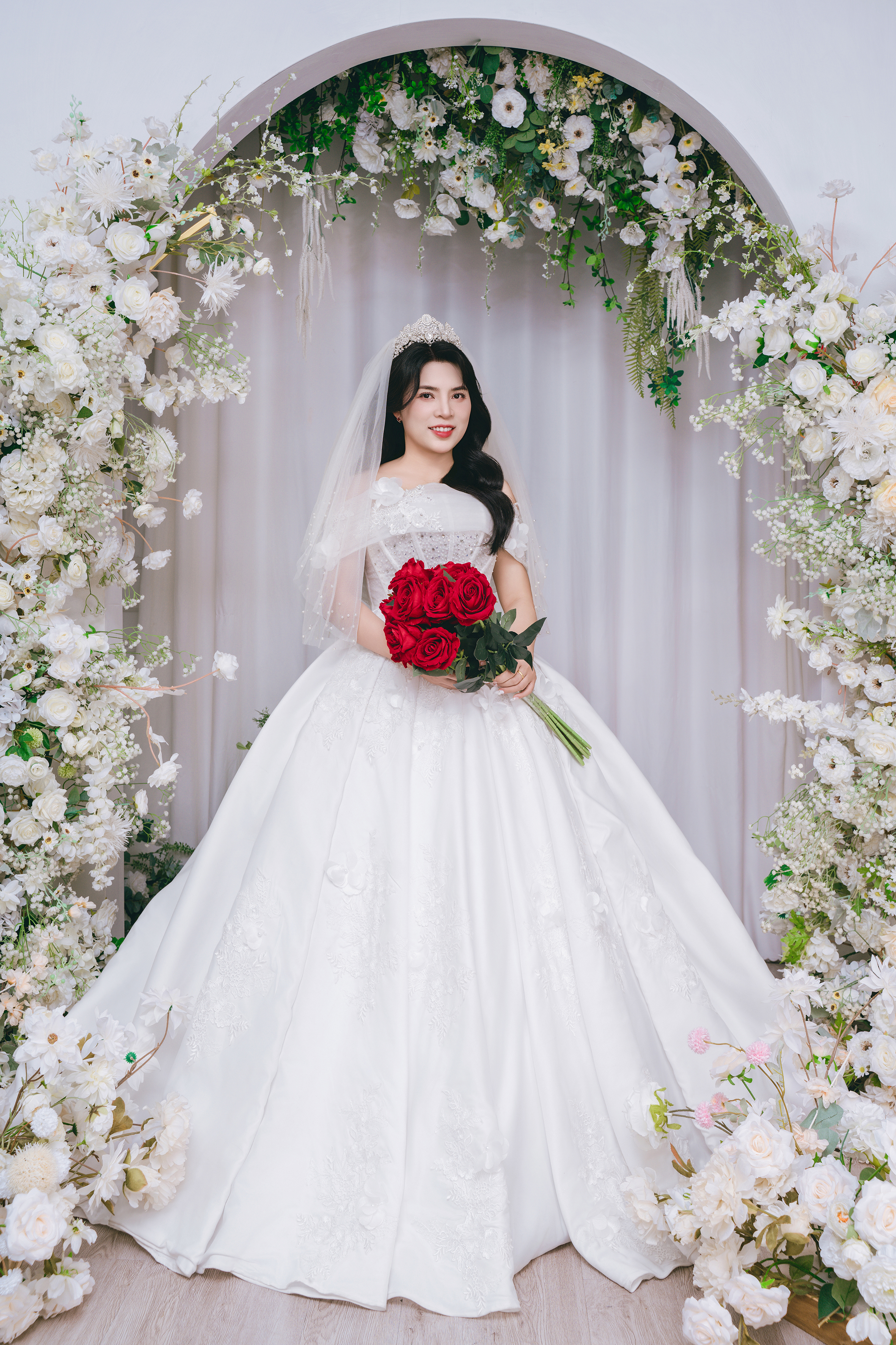 A bright pink sheet of paper used to wrap flowers curves in front of rich blue background